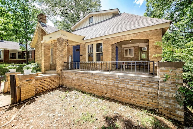 2420 Marshall St, Little Rock, AR 72206 - view of front of house with a chimney, roof with shingles, and brick siding
