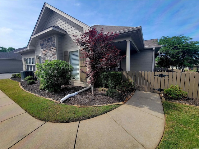 244 Mountain Terrace Cir, Maumelle, AR 72113 - view of front of property with fence, cooling unit, stone siding, and roof with shingles
