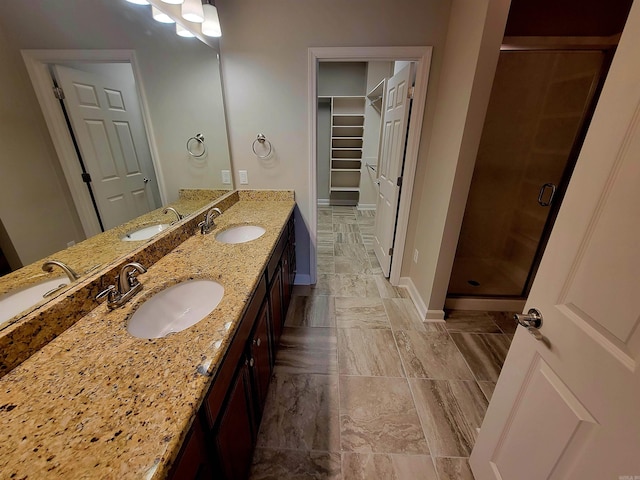244 Mountain Terrace Cir, Maumelle, AR 72113 - full bathroom with a stall shower, double vanity, a walk in closet, and baseboards