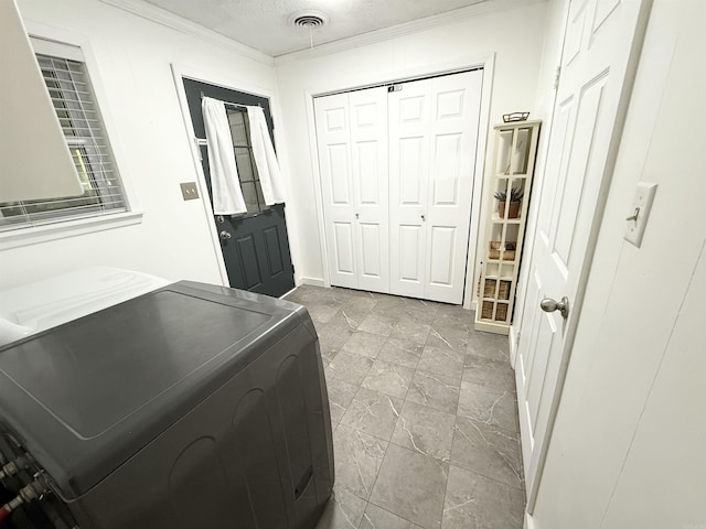 laundry room with independent washer and dryer, laundry area, visible vents, crown molding, and stone finish flooring