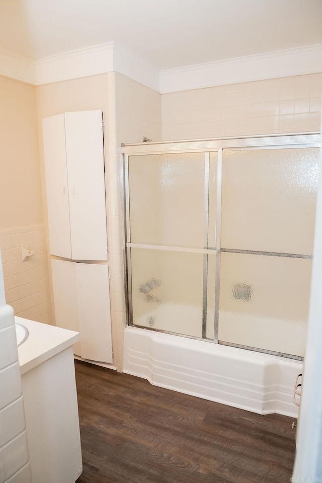 3801 S Hazel, Pine Bluff, AR 71603 - bathroom with enclosed tub / shower combo, wood finished floors, tile walls, vanity, and ornamental molding