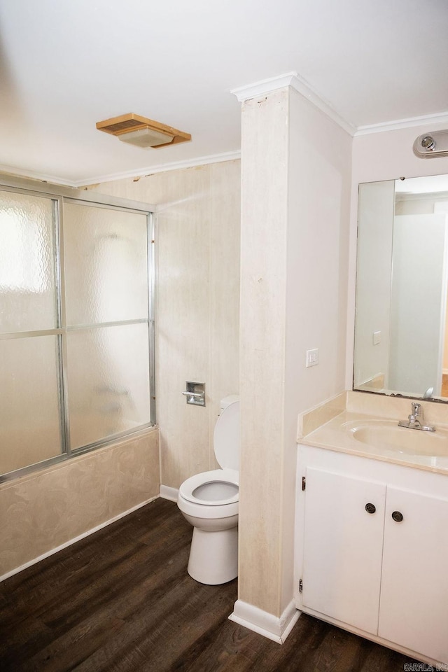3801 S Hazel, Pine Bluff, AR 71603 - bathroom featuring toilet, enclosed tub / shower combo, wood finished floors, vanity, and ornamental molding