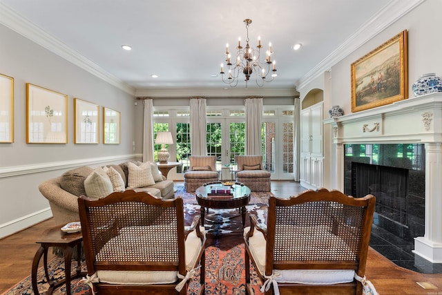 sitting room featuring a premium fireplace, crown molding, french doors, and recessed lighting