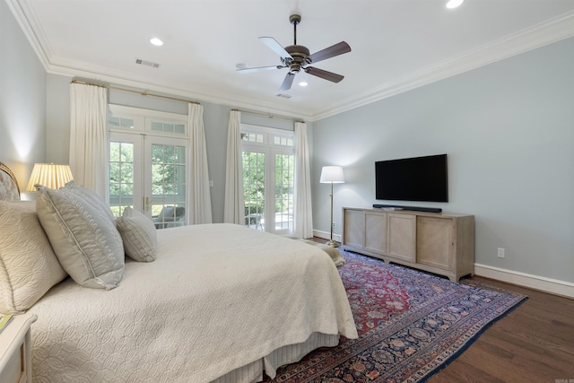 bedroom featuring baseboards, crown molding, visible vents, and wood finished floors