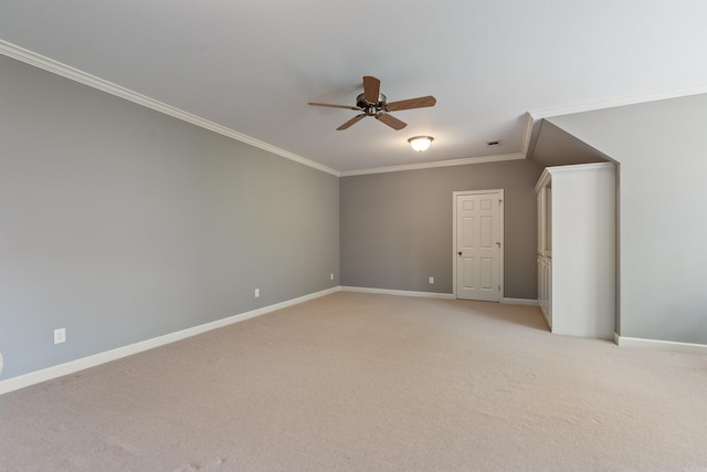 empty room with a ceiling fan, light carpet, baseboards, and crown molding
