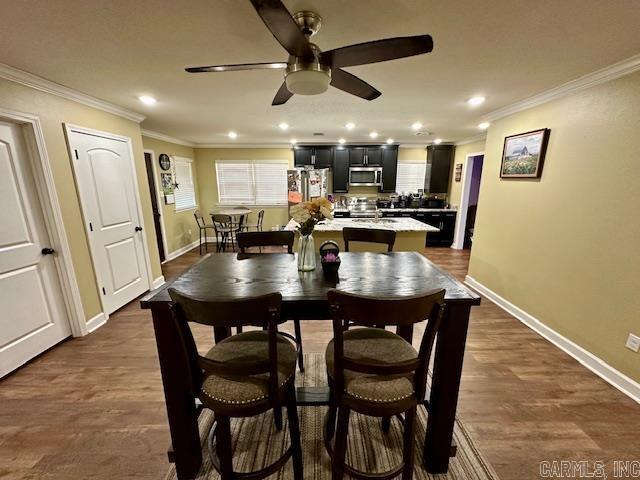 dining space featuring crown molding, baseboards, a ceiling fan, and recessed lighting