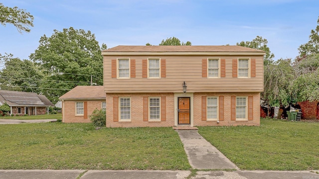 720 N 18th St, Blytheville, AR 72315 - colonial inspired home featuring brick siding and a front yard