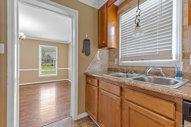 720 N 18th St, Blytheville, AR 72315 - kitchen with a sink, ornamental molding, light countertops, and decorative backsplash