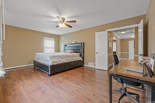 720 N 18th St, Blytheville, AR 72315 - bedroom with ceiling fan, baseboards, visible vents, and wood finished floors