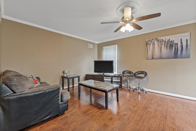 720 N 18th St, Blytheville, AR 72315 - living area featuring a ceiling fan, baseboards, ornamental molding, visible vents, and wood finished floors
