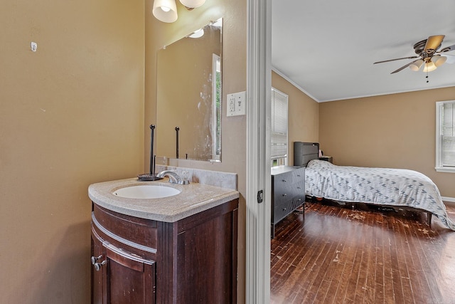 720 N 18th St, Blytheville, AR 72315 - bathroom featuring ornamental molding, wood finished floors, vanity, and ceiling fan