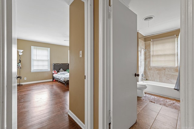 720 N 18th St, Blytheville, AR 72315 - corridor featuring baseboards, visible vents, and wood finished floors