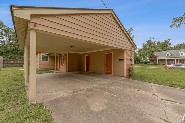 720 N 18th St, Blytheville, AR 72315 - view of front of house featuring a front yard, brick siding, fence, and a carport