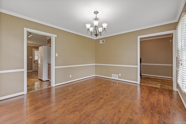 720 N 18th St, Blytheville, AR 72315 - spare room with a chandelier, visible vents, baseboards, and ornamental molding