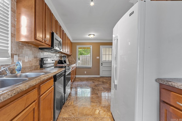 720 N 18th St, Blytheville, AR 72315 - kitchen with brown cabinetry, marble finish floor, appliances with stainless steel finishes, and a sink
