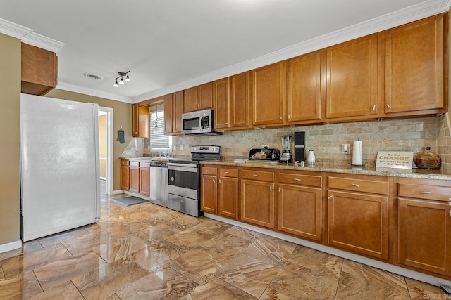 720 N 18th St, Blytheville, AR 72315 - kitchen featuring tasteful backsplash, brown cabinets, ornamental molding, light stone counters, and appliances with stainless steel finishes