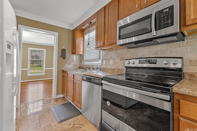 720 N 18th St, Blytheville, AR 72315 - kitchen featuring appliances with stainless steel finishes, brown cabinets, ornamental molding, and a sink
