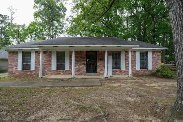 view of front of house with covered porch and brick siding