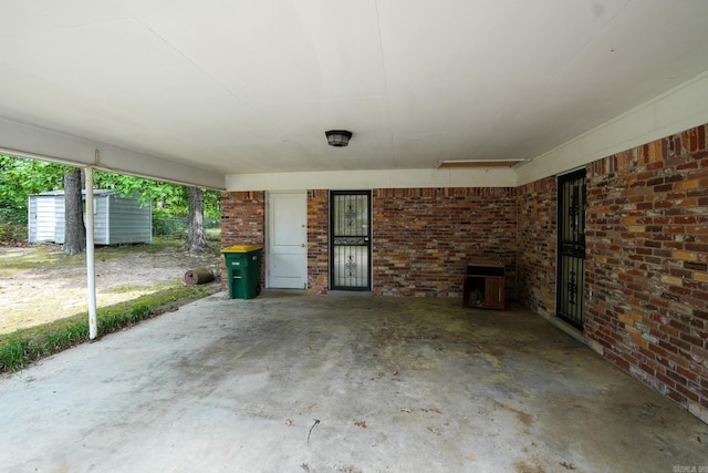 view of patio / terrace featuring a shed, an outbuilding, and a carport