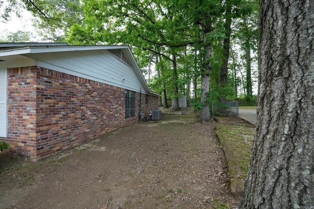 view of home's exterior featuring brick siding and central air condition unit