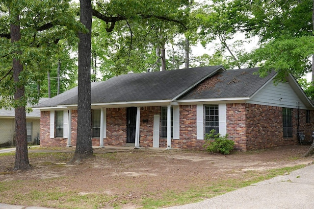 single story home featuring brick siding and covered porch