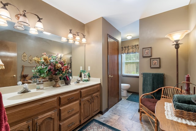 1000 Grandview Heights Dr, Conway, AR 72032 - bathroom featuring double vanity, stone finish floors, and toilet