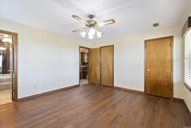 1000 Grandview Heights Dr, Conway, AR 72032 - unfurnished bedroom featuring wood finished floors, baseboards, connected bathroom, and ceiling fan