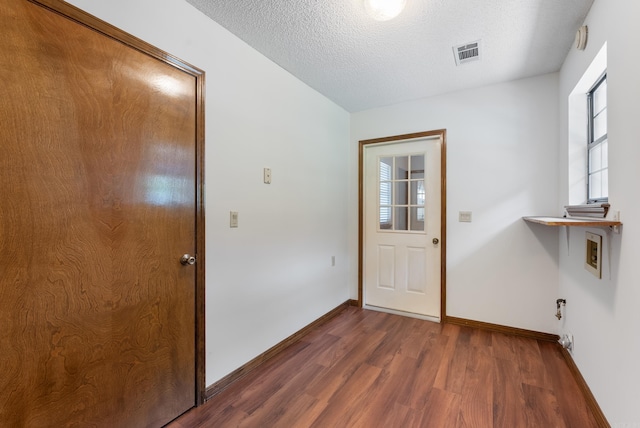 1000 Grandview Heights Dr, Conway, AR 72032 - doorway to outside featuring dark wood finished floors, baseboards, and a textured ceiling