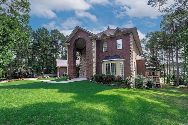 12 Loyola Ln, Hot Springs Village, AR 71909 - traditional home with a front lawn, a standing seam roof, brick siding, and a chimney