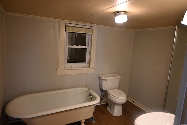 1304 W 9th St, North Little Rock, AR 72114 - bathroom with wood finished floors, toilet, and a freestanding bath