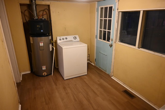 1304 W 9th St, North Little Rock, AR 72114 - laundry area featuring washer / dryer, hybrid water heater, and wood finished floors