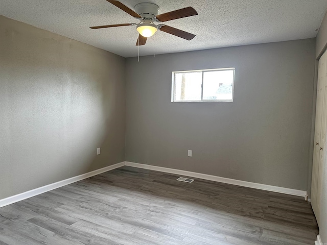 1720 Sanford Dr, Little Rock, AR 72227 - unfurnished room featuring wood finished floors, a ceiling fan, a textured ceiling, and baseboards