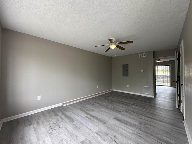 1720 Sanford Dr, Little Rock, AR 72227 - unfurnished room featuring ceiling fan, wood finished floors, electric panel, baseboards, and a textured ceiling