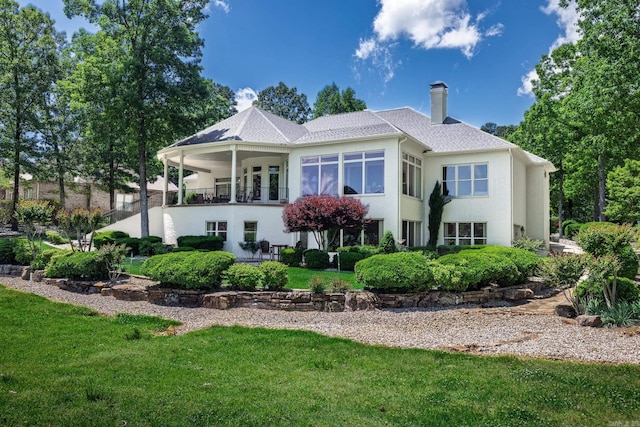 5 Granada Ln, Hot Springs Village, AR 71909 - rear view of property featuring a lawn, a patio, stucco siding, and a chimney