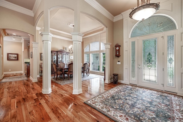 5 Granada Ln, Hot Springs Village, AR 71909 - foyer with ornate columns, light wood-style floors, crown molding, arched walkways, and baseboards