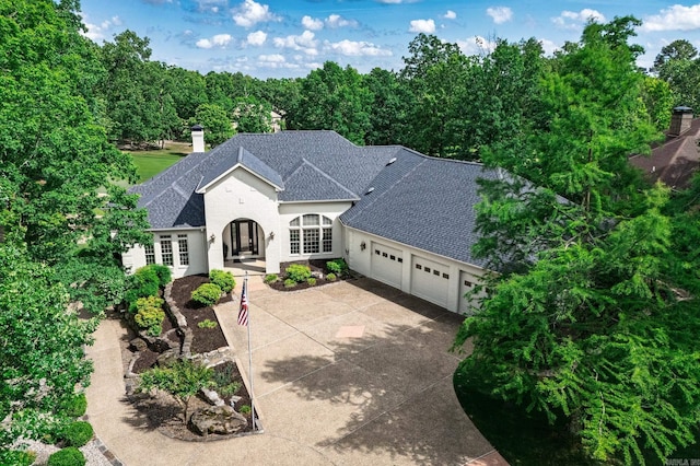5 Granada Ln, Hot Springs Village, AR 71909 - french provincial home featuring a garage, driveway, a shingled roof, and stucco siding
