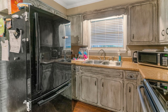718 Jones St, Sheridan, AR 72150 - kitchen featuring freestanding refrigerator, a sink, crown molding, stainless steel microwave, and light countertops