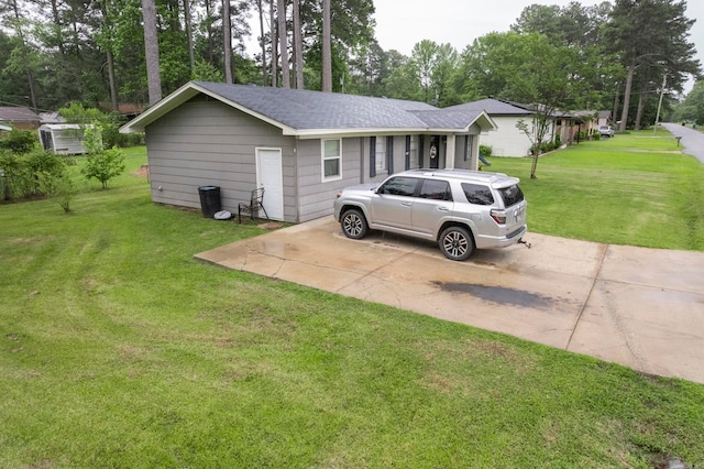 718 Jones St, Sheridan, AR 72150 - view of home's exterior featuring roof with shingles, a lawn, driveway, and view of scattered trees