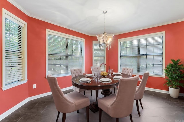 dining area featuring a chandelier, baseboards, and crown molding