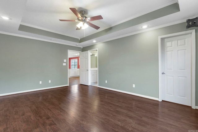empty room with a tray ceiling, ceiling fan, wood finished floors, crown molding, and recessed lighting