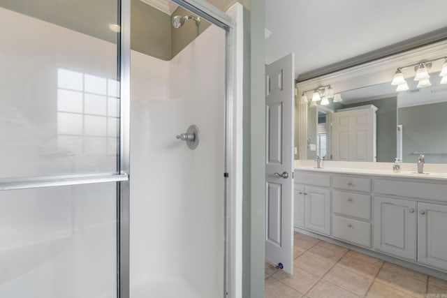 full bathroom with a shower stall, tile patterned flooring, double vanity, and ornamental molding