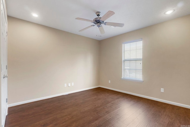 empty room featuring baseboards, dark wood-type flooring, ceiling fan, and recessed lighting