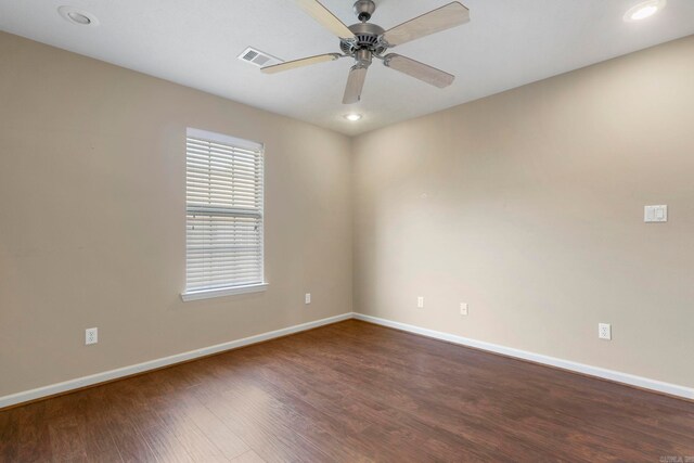 spare room with baseboards, dark wood finished floors, a ceiling fan, and recessed lighting