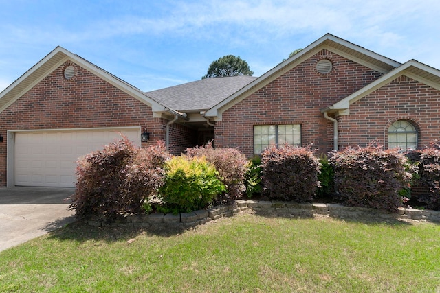 ranch-style house featuring brick siding, a front lawn, a garage, and concrete driveway