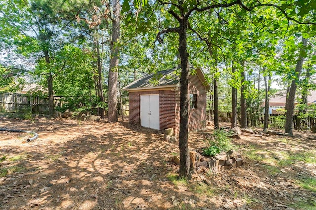 fenced backyard with an outbuilding and a storage shed