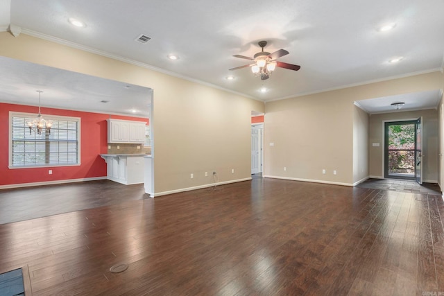 unfurnished living room featuring a ceiling fan, dark wood-style flooring, recessed lighting, baseboards, and a chandelier