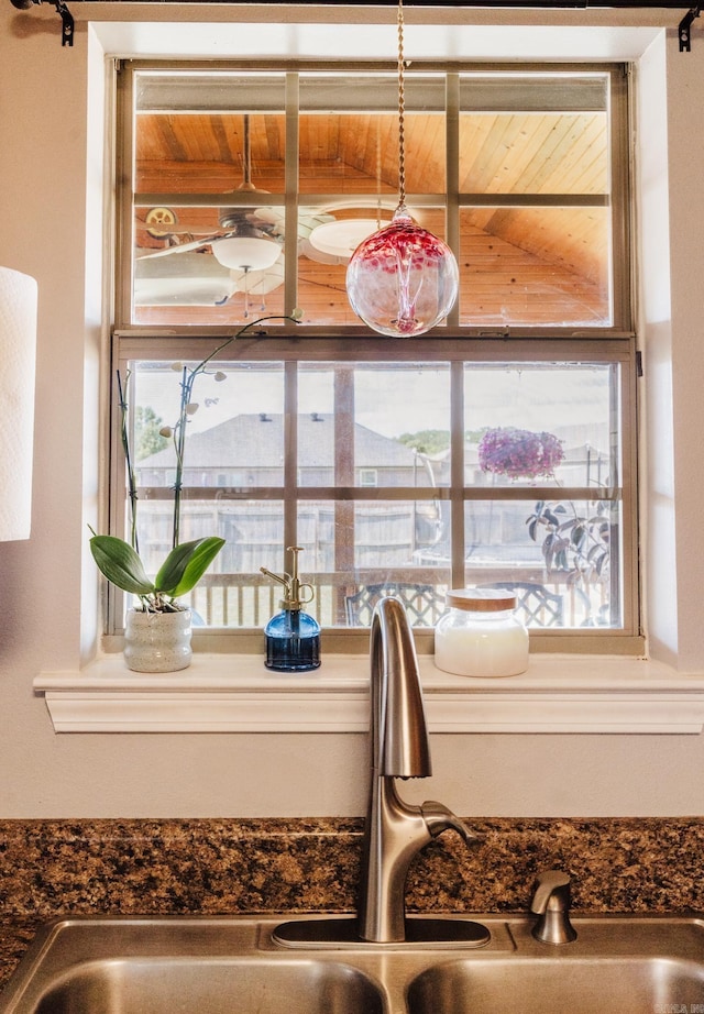 kitchen view of a sink and dark countertops