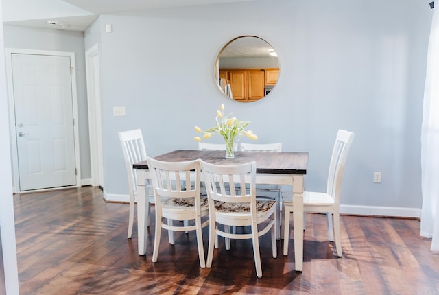 dining area featuring wood finished floors and baseboards