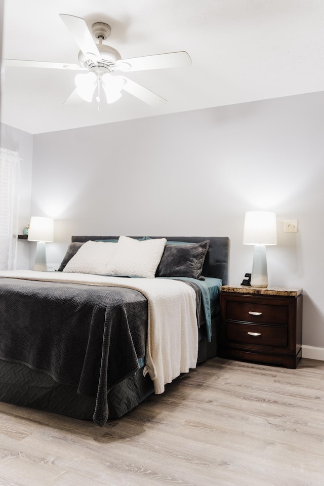 bedroom with light wood finished floors and ceiling fan