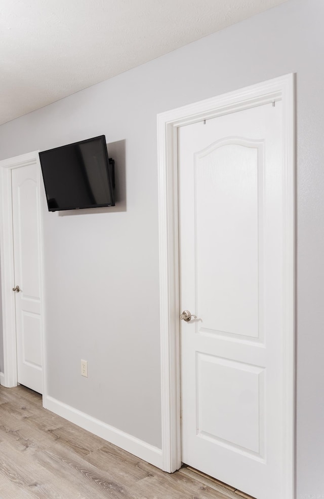 unfurnished bedroom with light wood-style floors and baseboards